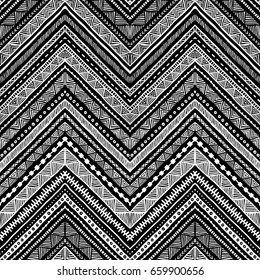 Seamless ethnic pattern drawn by hand. Black and white vector illustration. Chevron ornament, zigzag. Tribal and aztec motifs.