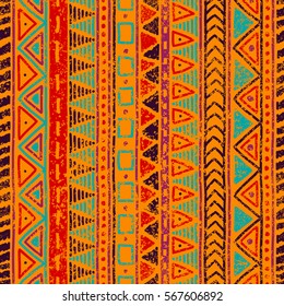 Seamless ethnic pattern. Grungy texture. Orange, blue, red and purple colors. Vintage vector illustration.
