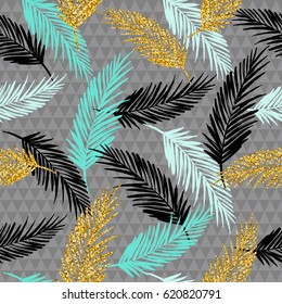 Seamless exotic pattern with palm leaf silhouettes. Gold glitter texture. Vector design.