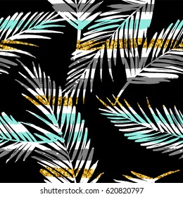 Seamless exotic pattern with palm leaf silhouettes. Gold glitter texture. Vector design.