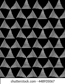 Seamless fashionable pattern of tribal african ornament consisting of triangles in lines. In black and white colors. Graphical hand drawn background. Vector illustration