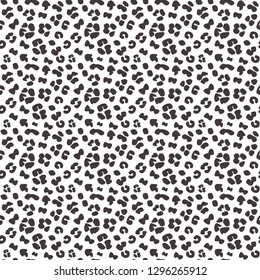Seamless faux leopard skin pattern with small black spots on white background. Vector - EPS.