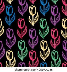 Seamless floral background with  pattern of tulips prints on black background. Printed cloth. Flowers painted with colored chalks