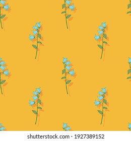 Seamless floral background.Pattern with bells. Blue bells on a yellow background.For decoration of fabric, paper, packaging, wallpaper.Blue flowers.