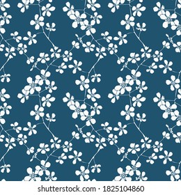 Seamless floral background.Pattern with flowers and buds.White silhouettes of flowers on a blue background.For decoration of fabric,paper,packaging, Wallpaper.