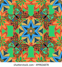 Seamless floral mandala pattern in pink, turquoise green, blue and pale orange on floral orange background.