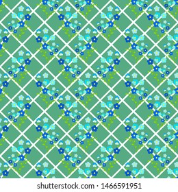 Seamless floral pattern of blue-violet twigs of forget-me-not flowers, on a background with green squares, rhombuses. Great for decorating fabrics, textiles, gift wrapping, printed materials or other.