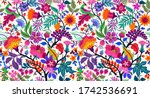 Seamless floral pattern with bright colorful flowers and tropic leaves on a white background. The elegant the template for fashion prints. Modern floral background. Trendy Folk style.