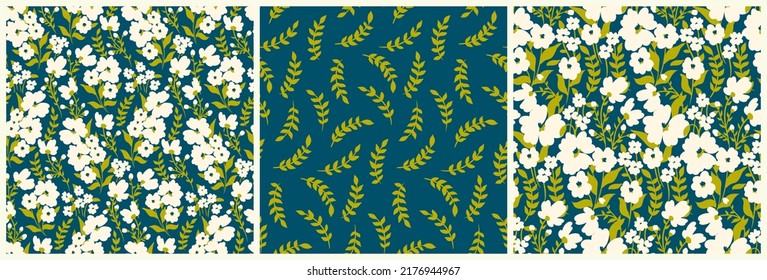 Seamless floral pattern with decorative flowers meadow in the set. Collection with ditsy print, botanical background design with small hand drawn plants, white flowers, leaves on blue field. Vector.