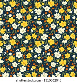 Seamless floral pattern for design. Small yellow and white flowers. Blue background. Modern floral texture. A allover floral design in bright colors. The elegant the template for fashion prints.