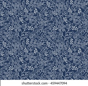 Seamless floral pattern for design. Small white flowers and leaves. Dark blue fond. Modern floral background. The elegant the template for fashion prints.