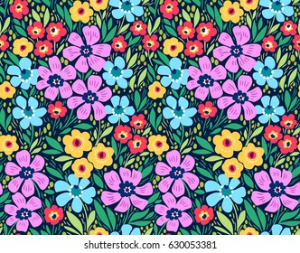 Seamless floral pattern for design. Small multicolored flowers. Dark blue background. Modern floral texture. A allover floral design in bright colors. The elegant the template for fashion prints.