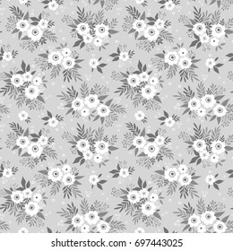 Seamless floral pattern for design. Small white flowers and leaves. Light gray background. Modern floral texture. A allover floral design in bright colors. The elegant the template for fashion prints.