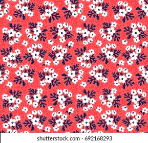 Seamless floral pattern for design. Small-scale white flowers and leaves. Red background. Modern floral texture. A allover floral design in bright colors. The elegant the template for fashion prints.