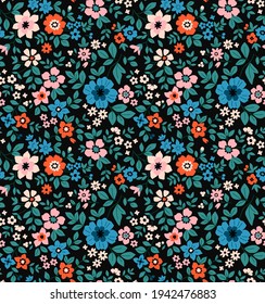 Seamless floral pattern. Ditsy background of small colorful flowers and green leaves. Small-scale flowers scattered over a dark blue background. Stock vector for printing on surfaces and web design.