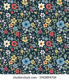 Seamless floral pattern. Ditsy background of small colorful  flowers. Small-scale flowers scattered over a dark blue background. Stock vector for printing on surfaces and web design.