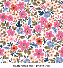 Seamless floral pattern. Ditsy background of small pink and blue  flowers. Small-scale flowers scattered over a white background. Stock vector for printing on surfaces and web design.