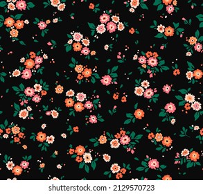 Seamless floral pattern. Ditsy background of small orange flowers. Vector pattern. Elegant template for fashion prints. Black background. Summer and spring motifs.