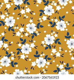 Seamless floral pattern. Fashionable background of white flowers, dark blue leaves. flowers scattered on a mustard background. Stock vector for printing on surfaces and web design.