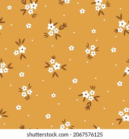 Seamless floral pattern. Fashionable background of white flowers and dots, brown leaves. flowers scattered on a mustard background. Stock vector for printing on surfaces and web design.