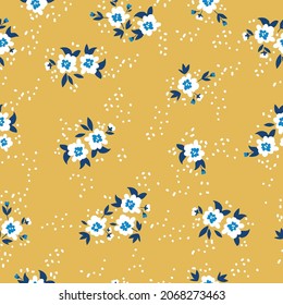 Seamless floral pattern. Fashionable background of white flowers and dots, green leaves. flowers scattered on a mustard background. Stock vector for printing on surfaces and web design.