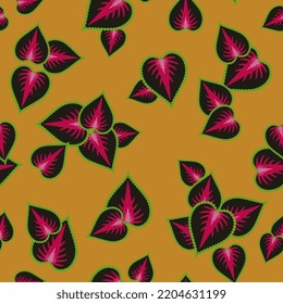 Seamless floral pattern with leaves of Coleus scutellarioides plant. Heart shape floral design. On yellow orange background.
