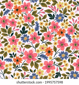 Seamless floral pattern. Liberty background of small colorful flowers. Folk flowers scattered over a white background. Stock vector for printing on surfaces and web design.