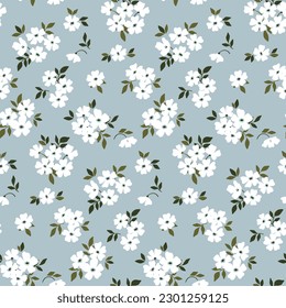 Seamless floral pattern, liberty ditsy print with rustic motif. Romantic botanical design for fabric, paper: hand drawn plants, small white flowers, tiny leaves on blue background. Vector illustration