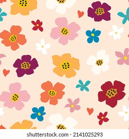 Seamless floral pattern. Multicolored simple flowers on a pastel pink background.