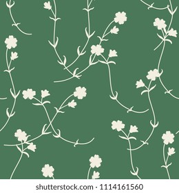 Seamless floral pattern with silhouettes of wild meadow flowers.