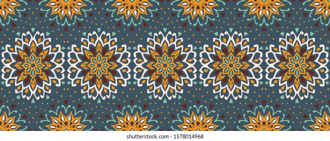 Seamless floral pattern. Stylized doodle flowers. Spanish ethnic embroidery. Folk ornament. Solar sign. Mediterranean print. Indian Oriental or Turkish textiles. Boho wallpaper. Hipster art.