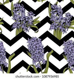 Seamless floral pattern. Violet Hyacinth flowers and leaves on a zig zag geometric background. Vector illustration.