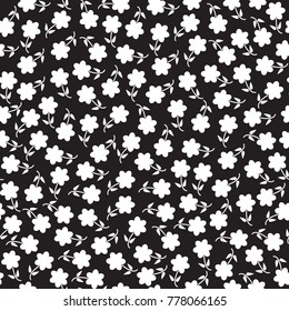 Seamless floral pattern. White little flowers on the black background. Vector illustration.