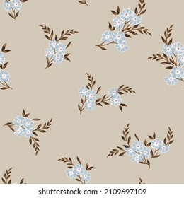 seamless floral vector blue small flowers with brown leaves bunches pattern on cream background