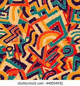 Seamless geometric background. Ethnic and tribal motifs. Hatching of colored elements. Print for carpet, rugs, textiles. Vector illustration.