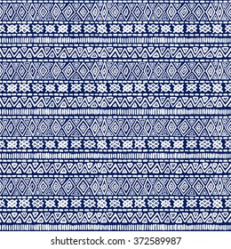 Seamless geometric ethnic pattern. Blue and white structure of the traditional folk forms. Vector painted hands.