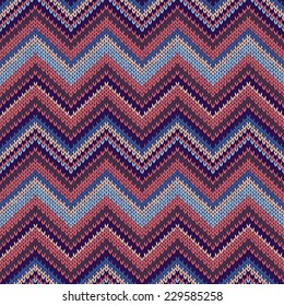 Seamless geometric ethnic spokes knitted pattern. Blue white orange red color knitwear sample