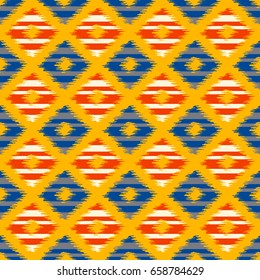 Seamless geometric pattern, based on ikat fabric style. Vector illustration. Carpet rug texture vector imitation. Blue and orange checkered ikkat pattern.