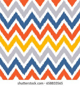 Seamless geometric pattern, based on ikat fabric style. Vector illustration. Carpet rug texture vector imitation. Yellow and gray chevron pattern.