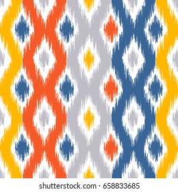 Seamless geometric pattern, based on ikat fabric style. Vector illustration. Carpet rug texture vector imitation. Yellow, red, blue and grey ogee pattern.