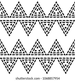 Seamless geometric pattern. Black and white texture. Drawn triangles. Drops texture. Brushwork. Scribble texture. Textile rapport.