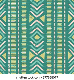 Seamless geometric pattern with ethnic motifs in vibrant green and yellow colors.