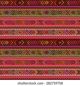 Seamless geometric pattern in ethnic style, a bright structure of rhombus, triangle and zigzags.