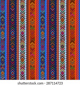 Seamless geometric pattern in ethnic style, a bright structure of rhombus, triangle and zigzags.