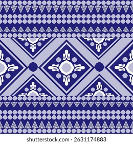 A seamless geometric pattern featuring stylized diamond shapes and intricate ethnic-inspired motifs in white over a rich indigo blue background. The design is arranged in horizontal stripes.