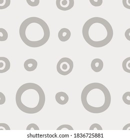 Seamless geometric pattern with hand drawn uneven gray rings of different size on beige background for surface design and other design projects