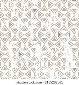 Seamless geometric pattern in oriental style with an effect of attrition. Abstract beige color triangle texture pattern.