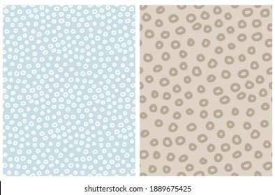 Seamless Geometric Vector Pattern. Simple Irregular Abstract Dotted Print with Brown and White Hand Drawn Circles Isolated on a Beige and Pastel Blue Background. Template with Confetti Rain Design.