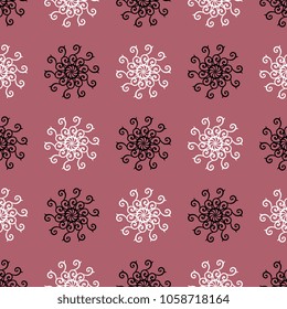 Seamless geometrical abstract pattern with ornate round floral mandalas. Black and white silhouettes on mauve pink background.