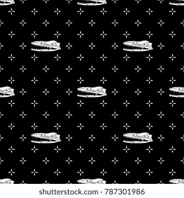 Seamless geometrical black and white pattern with snake skulls and tiny crosses.